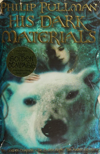 Cover of the His Dark Materials omnibus edition by Philip Pullman, showing an armored polar bear's face beside an illustrated portrait of a young girl in icy blue tones